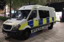 A man has been arrested for urinating against a police van in Warrington town centre
