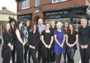 Gill Ferguson (in blue dress) with her staff at Macadamia Hair Spa