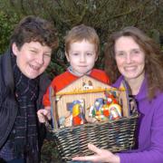Karen Gay with Charlie Hext, four, and Kate Hext who looked after the village's nativity scene for the night