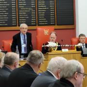 Council leader Mike Wharton addresses members at Runcorn Town Hall last night.