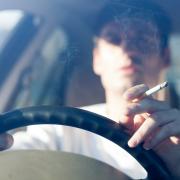 Smokers could face fines for smoking behind the wheel, even though it is not illegal