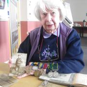 Elsie Lewis with some of her father's medals and photographs