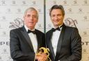 John Booth from Booths of Ditton team receives the award from Stéphane Le Guével, managing director of Peugeot UK.