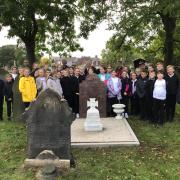 Victoria Road Primary School pupils at Thomas 'Todger' Jones' grave in Runcorn Cemetery
