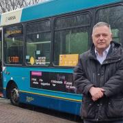 Weaver Vale MP Mike Amesbury stood in front of a bus