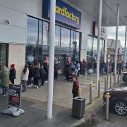 Shoppers queue to visit The Range in Widnes