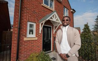 Abzee Amao stood outside his new home in Sandymoor